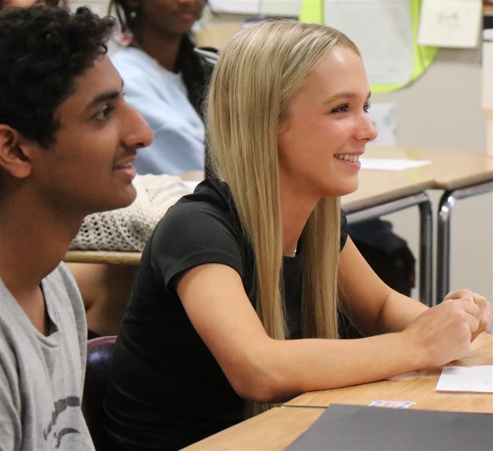  Two Rockwood students smile as they engage with a discussion in an AP class.
